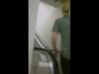 Captivating ass on an escalator in yoga pants